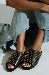 AKIRA BAGGER STUDDED SLIP ON SANDAL IN BLACK
